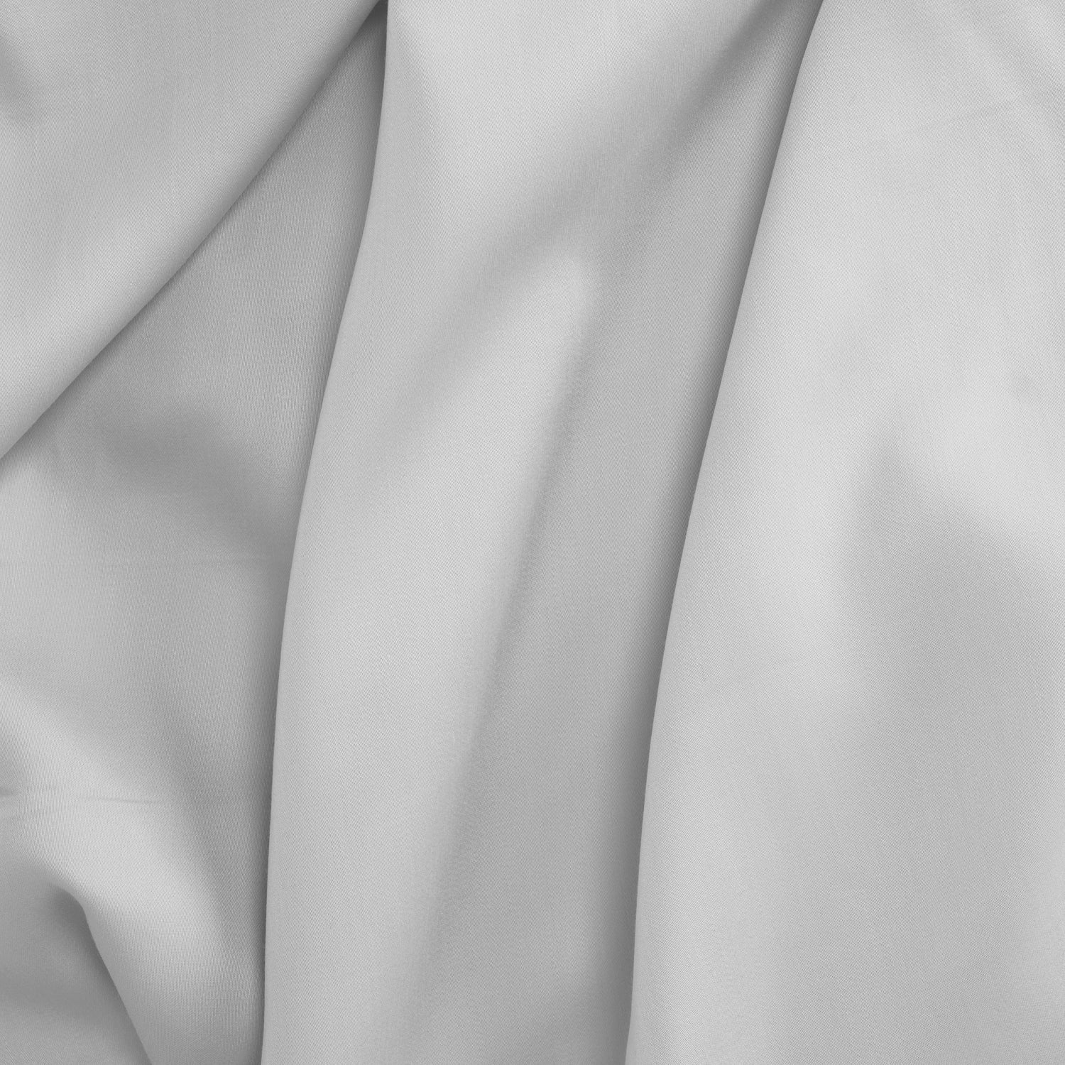 Smooth white Tencel sateen flat sheet with a soft, lustrous finish and gentle folds.