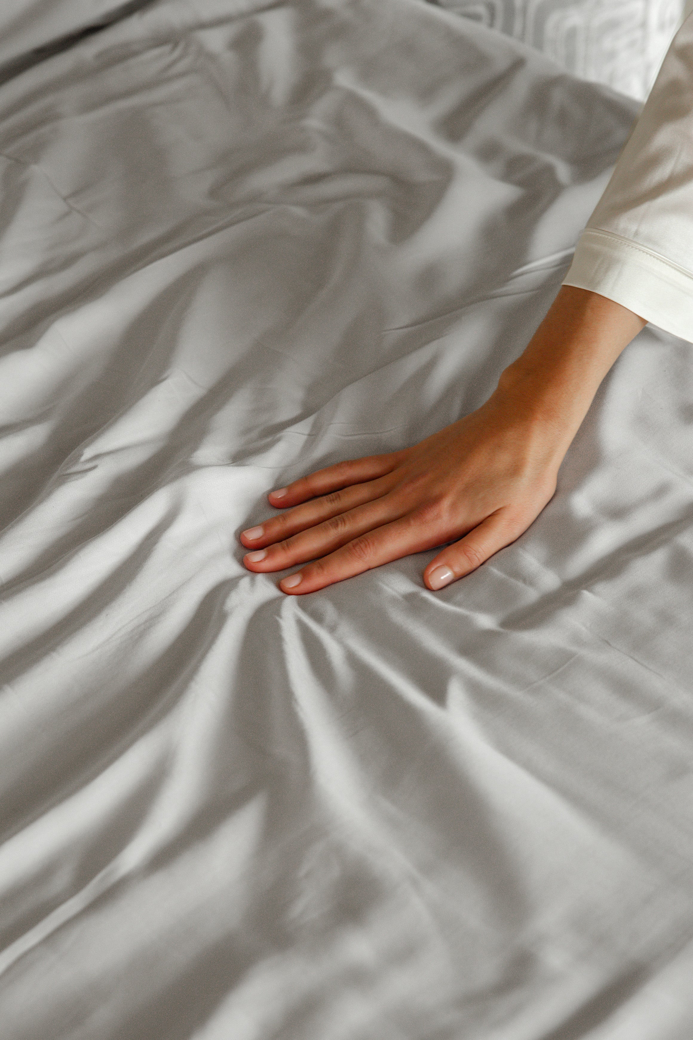 Soft calm grey Tencel™ sateen flat sheet with smooth, luxurious texture and subtle sheen.