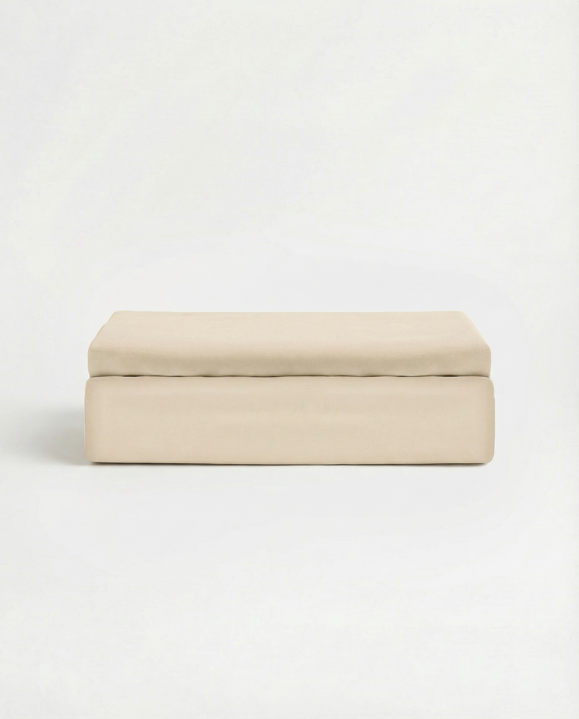 Classic ivory folded flat sheet in smooth Tencel sateen fabric against white background.