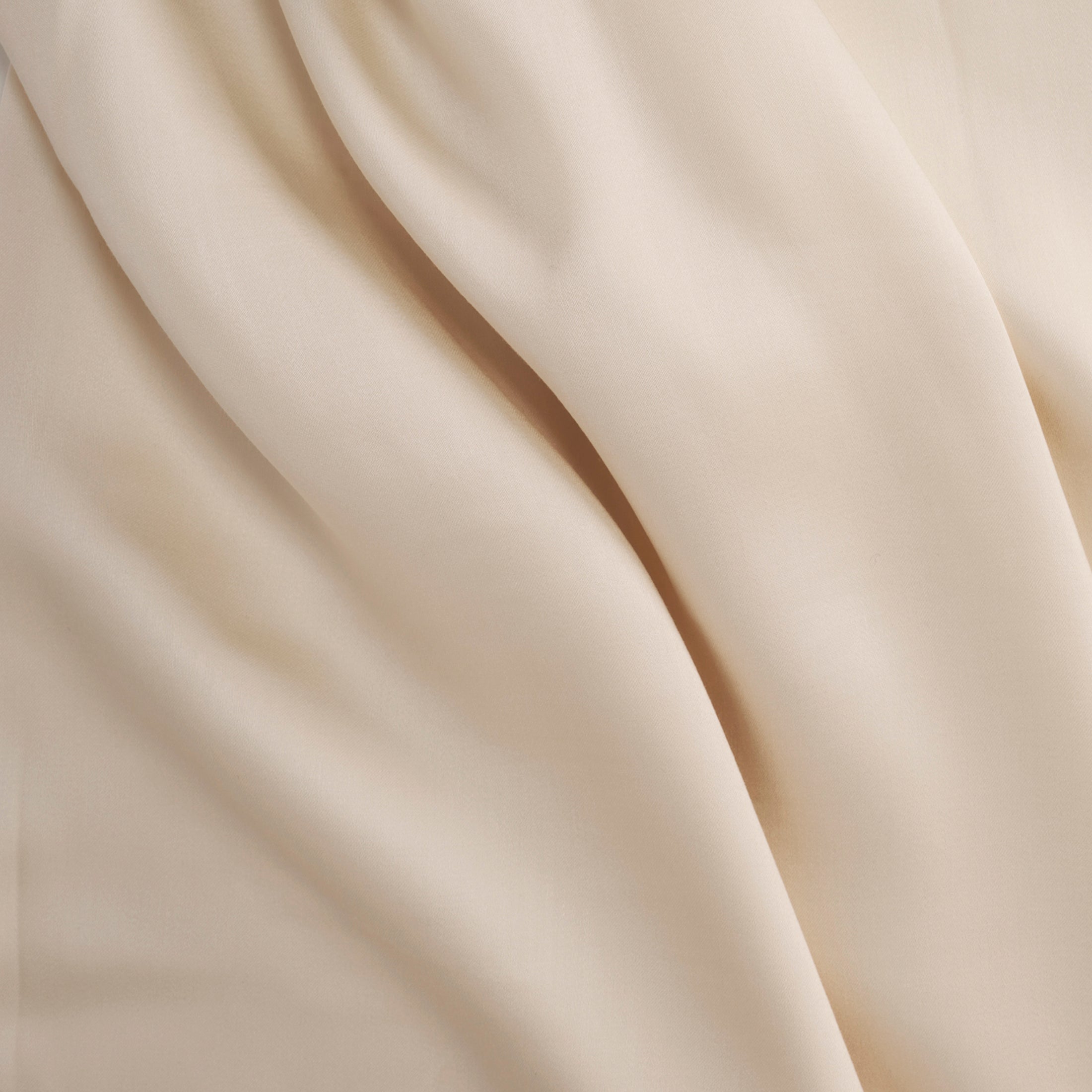 Soft classic ivory Tencel sateen flat sheet with smooth, flowing texture and subtle sheen.