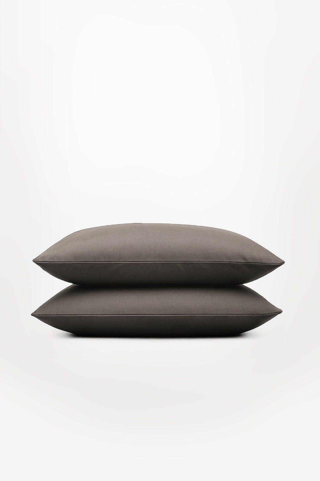 Two stacked moonstone grey pillowcases with a smooth, sateen finish on a white background.
