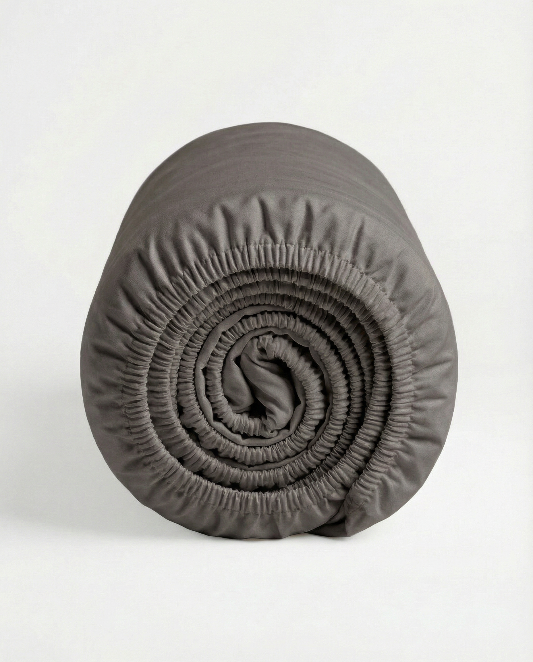 Rolled calm grey fitted sheet made from smooth Tencel™ sateen fabric.