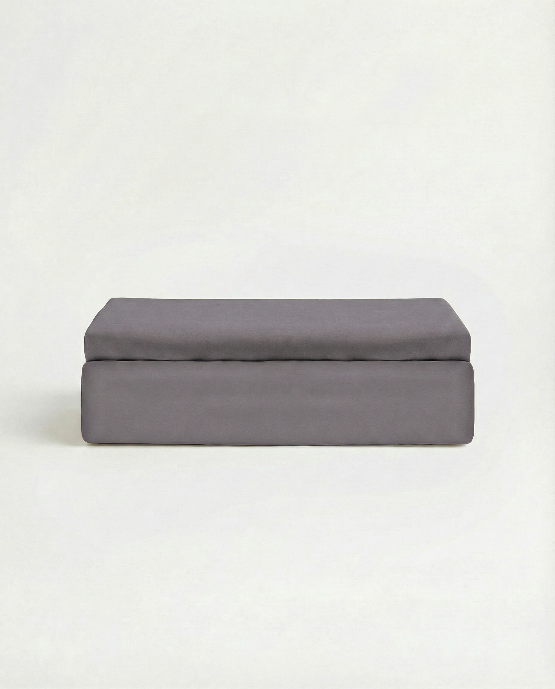 Folded moonstone grey Tencel™ sateen flat sheet with smooth, lustrous finish.