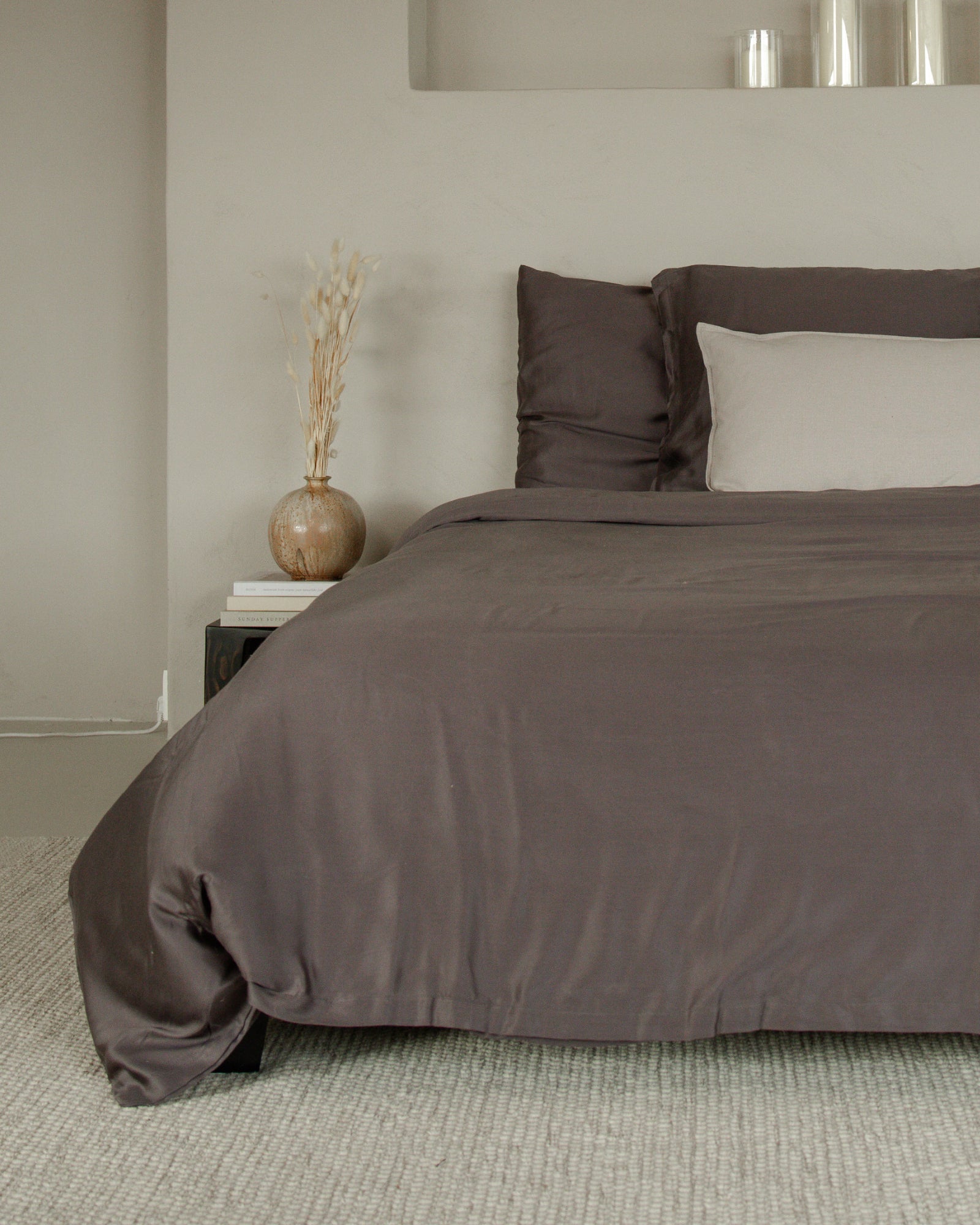Calm grey Tencel sateen duvet cover set with matching pillowcases on bed in neutral room.
