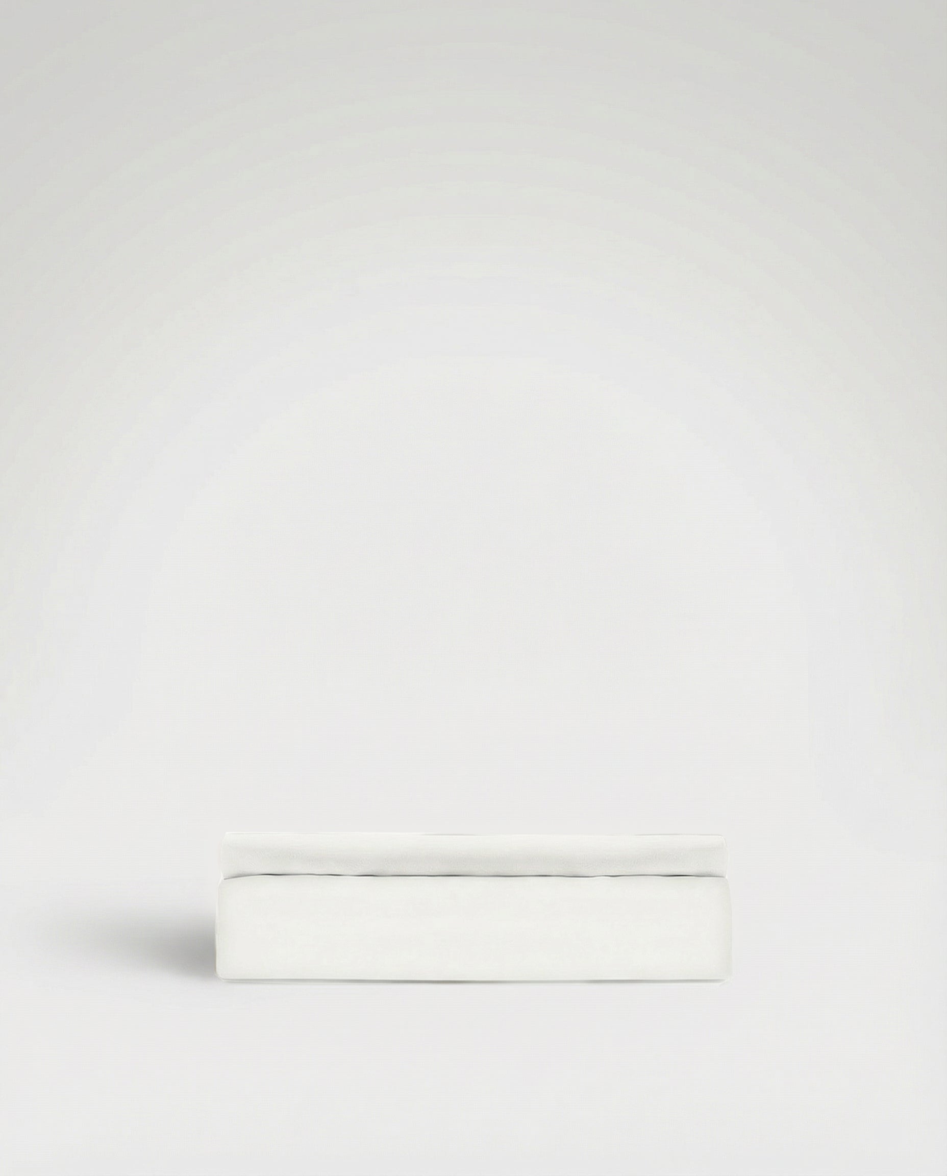 Signature White Tencel™ Sateen flat sheet neatly folded against a plain light background.