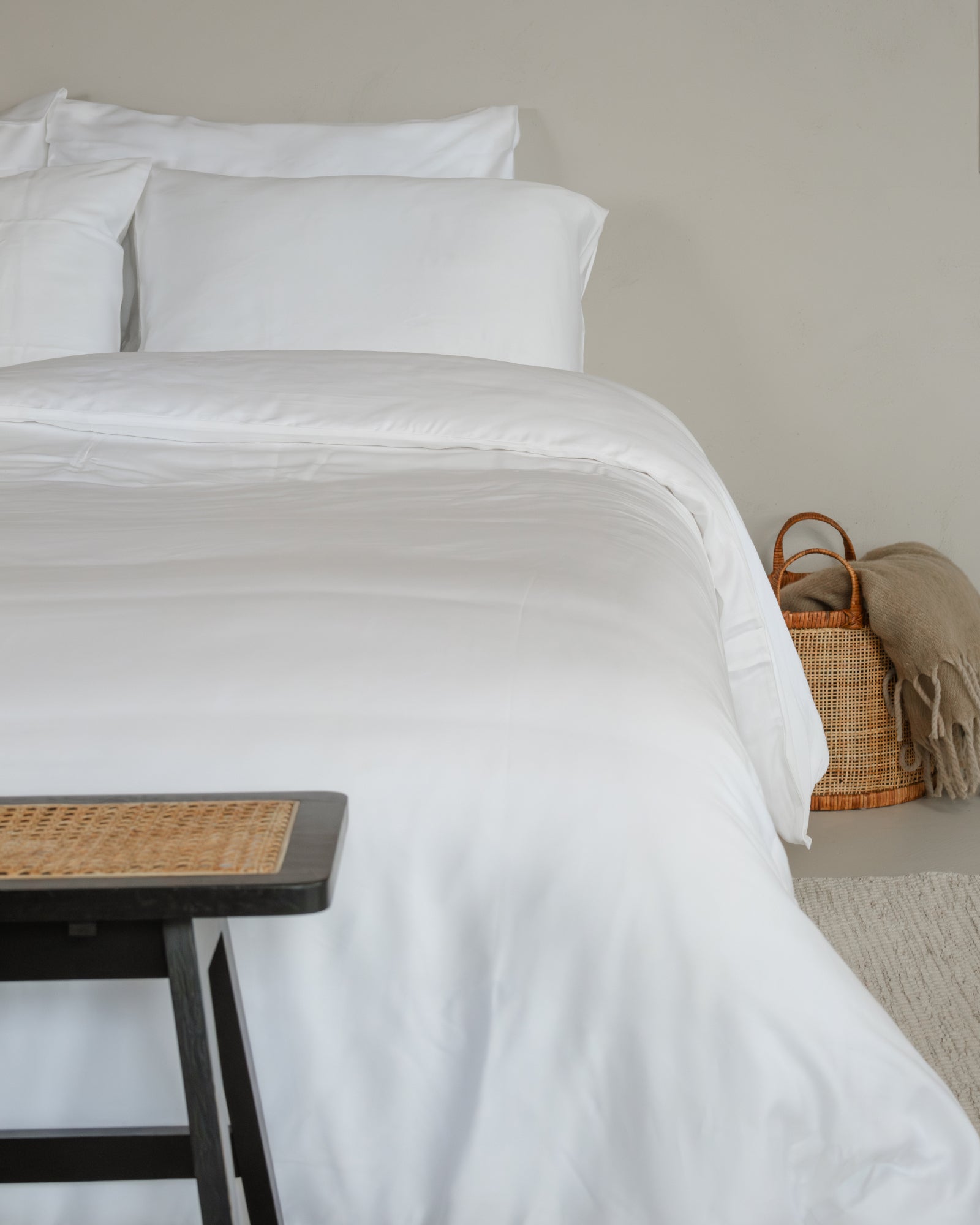 Crisp white Tencel sateen duvet cover set with matching pillowcases on a neatly made bed.