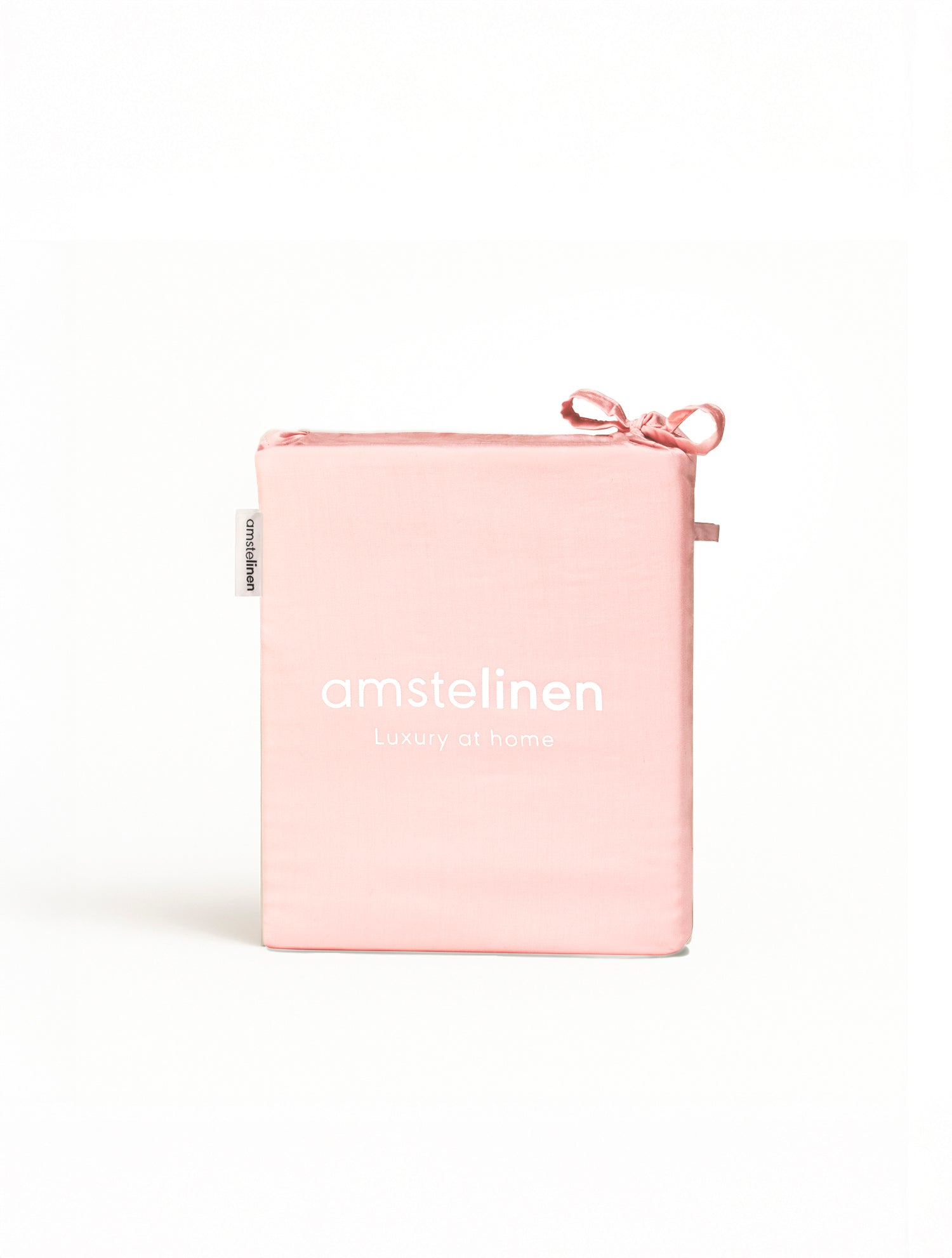 Soft pink Tencel™ sateen flat sheet neatly folded with tied ribbon on white background.